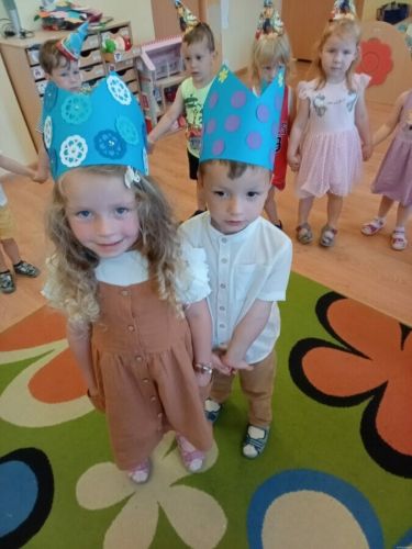 Dzieci tańczą w kole.